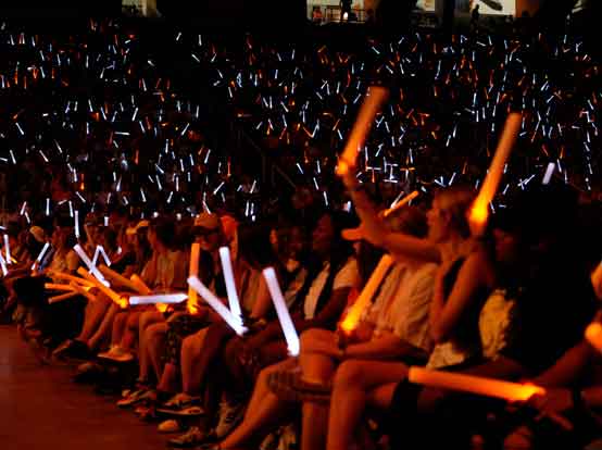 Tennessee students at a pep rally with orange and white glow sticks