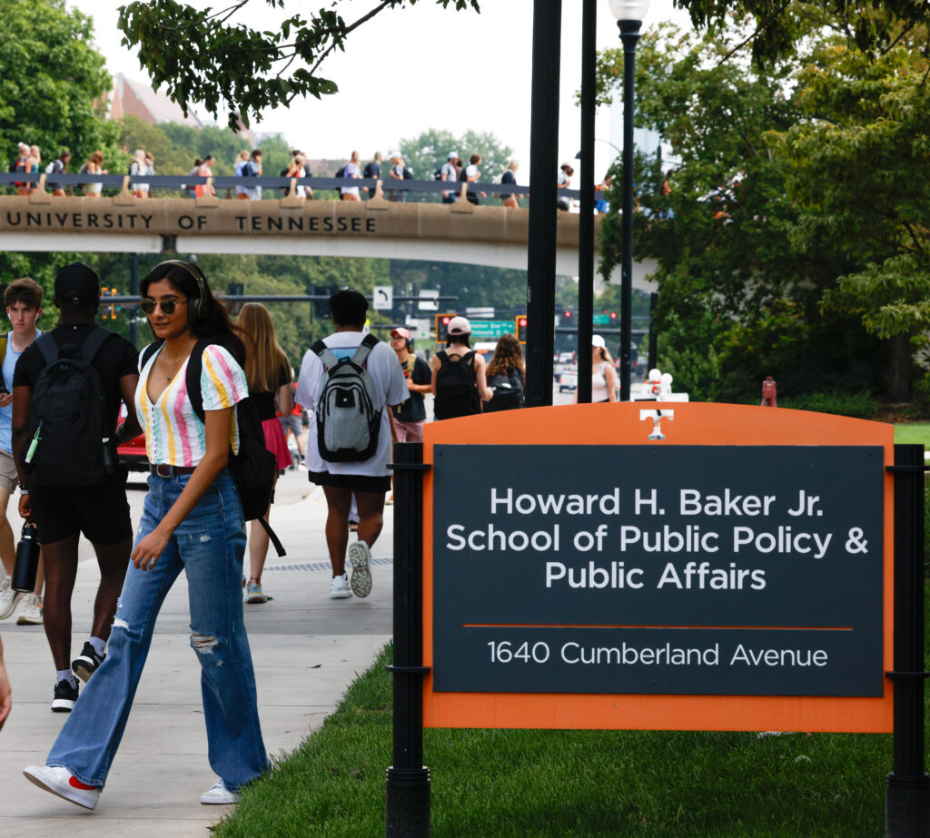 Students walking by the Baker School sign.
