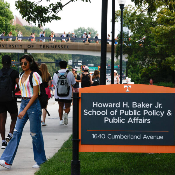 Students walking by the Baker School sign.