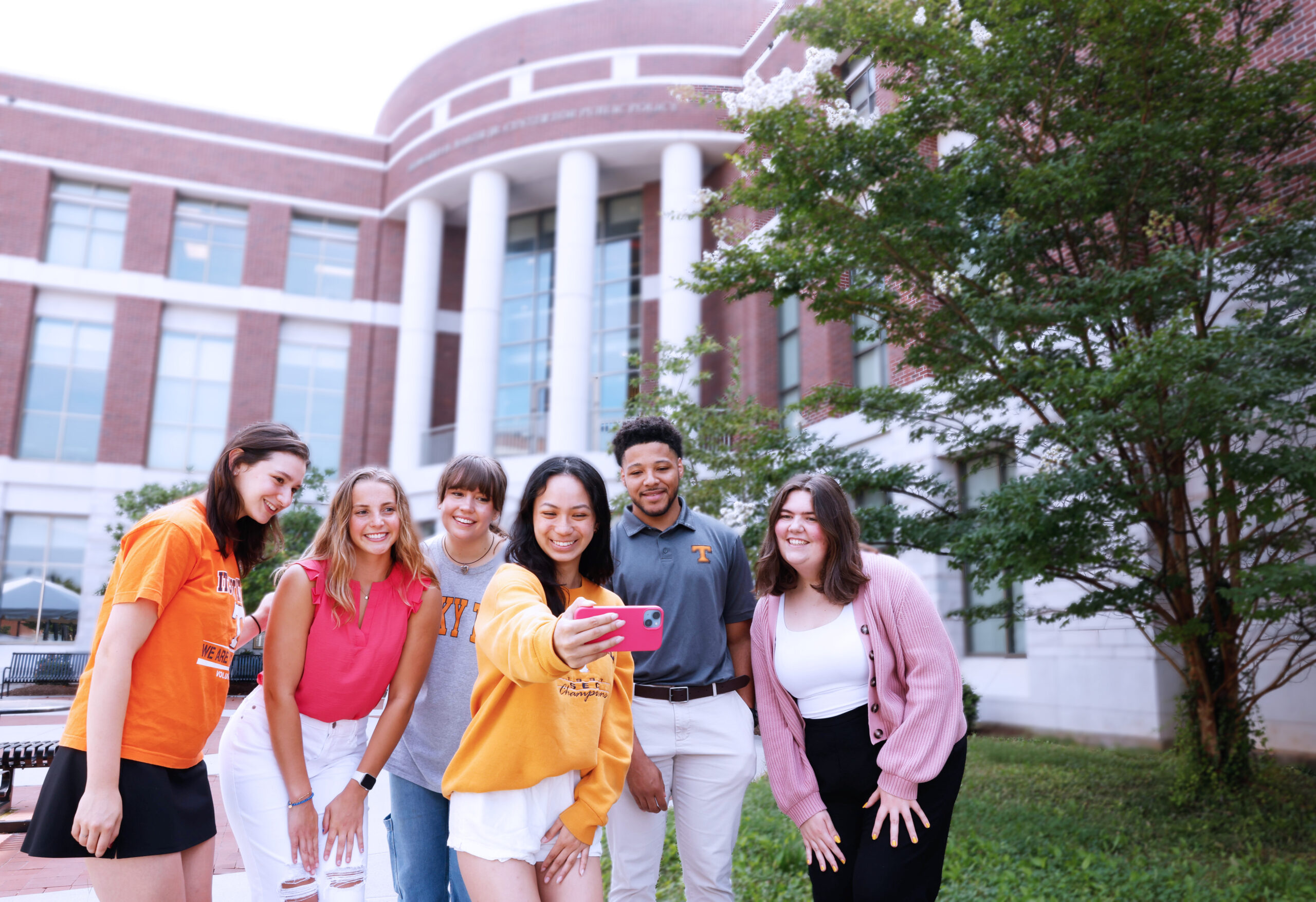 A photo of Baker School undergraduate students taking a selfie in front of the Baker Building