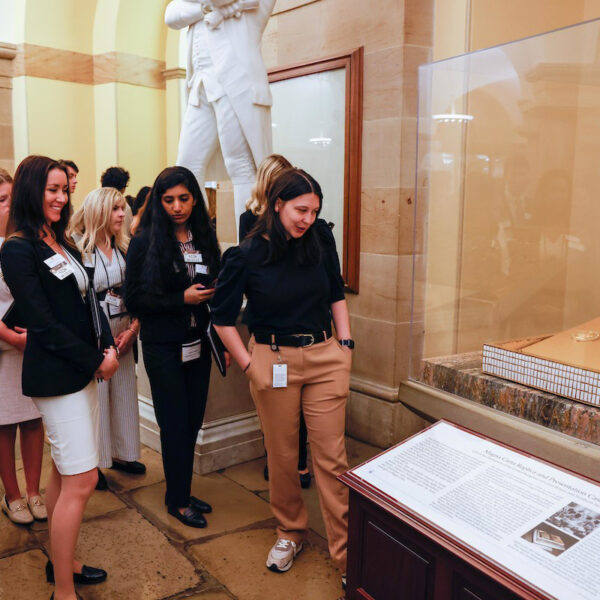 Students in D.C. looking at documents in a case.