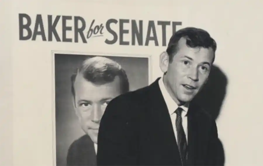 A photo of a young Howard Baker in front of a sign reading Baker for Senate
