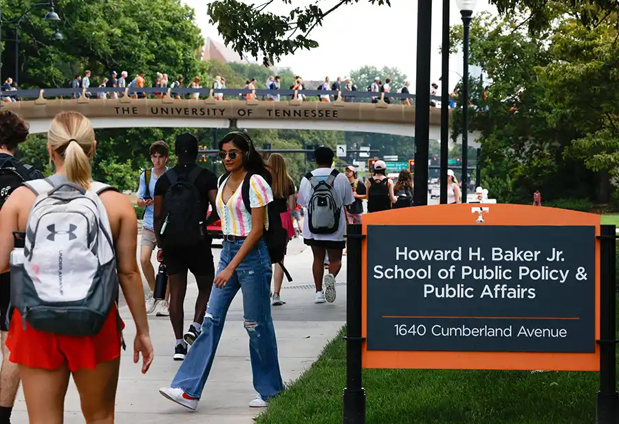 Undergraduates with the Baker School sign on campus of UT