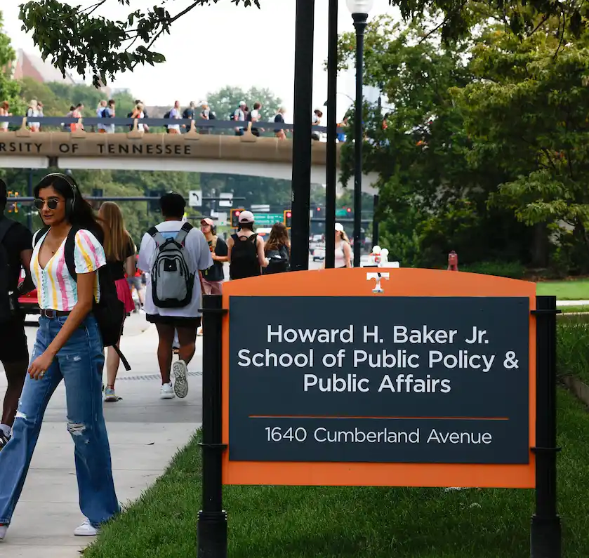 Howard H. Baker School of Public Policy and Public Affairs Sign with students walking in background.