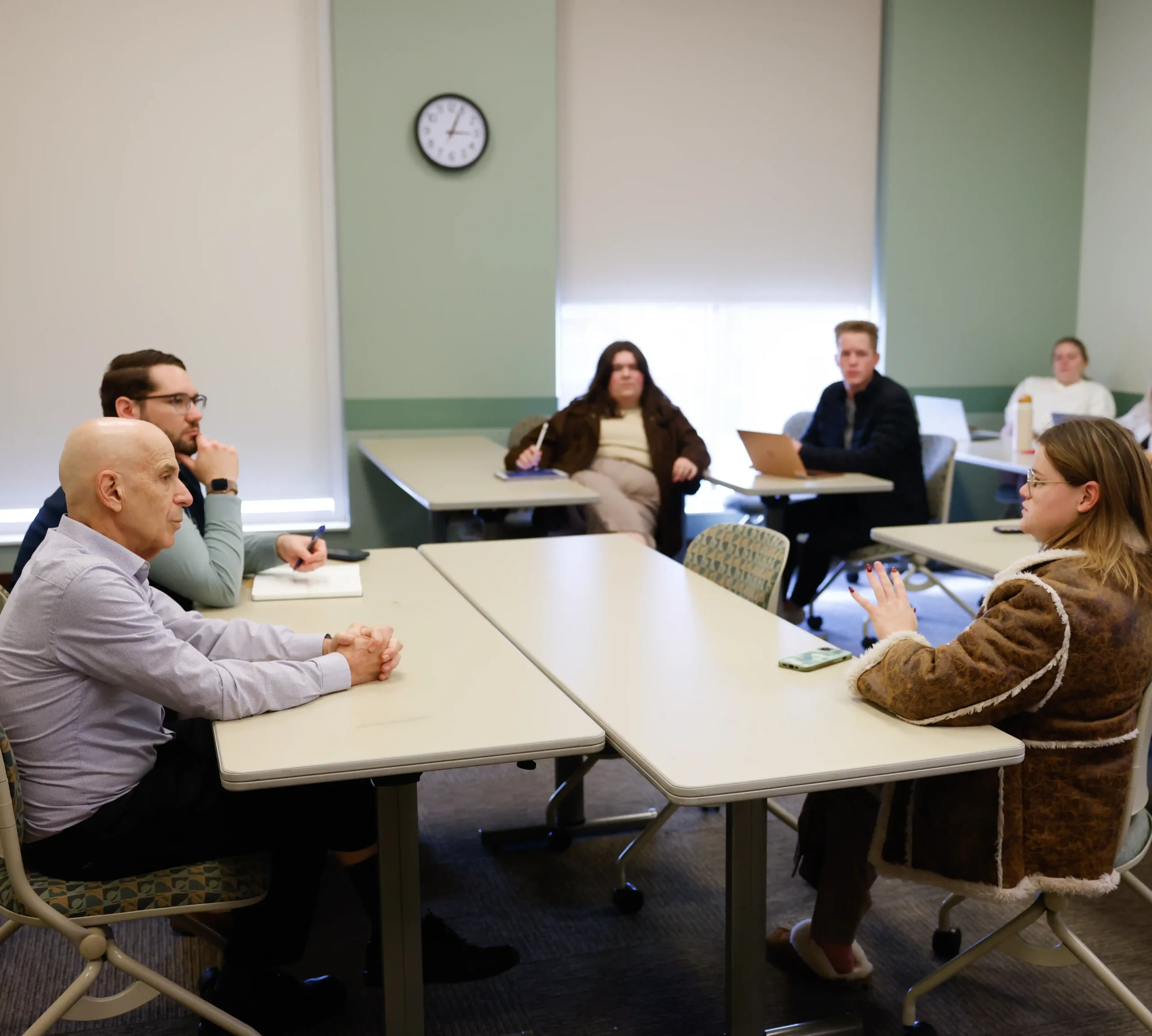 Bill Lyons speaking with students