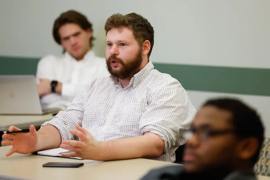 Picture of student looking ahead and speaking in a classroom